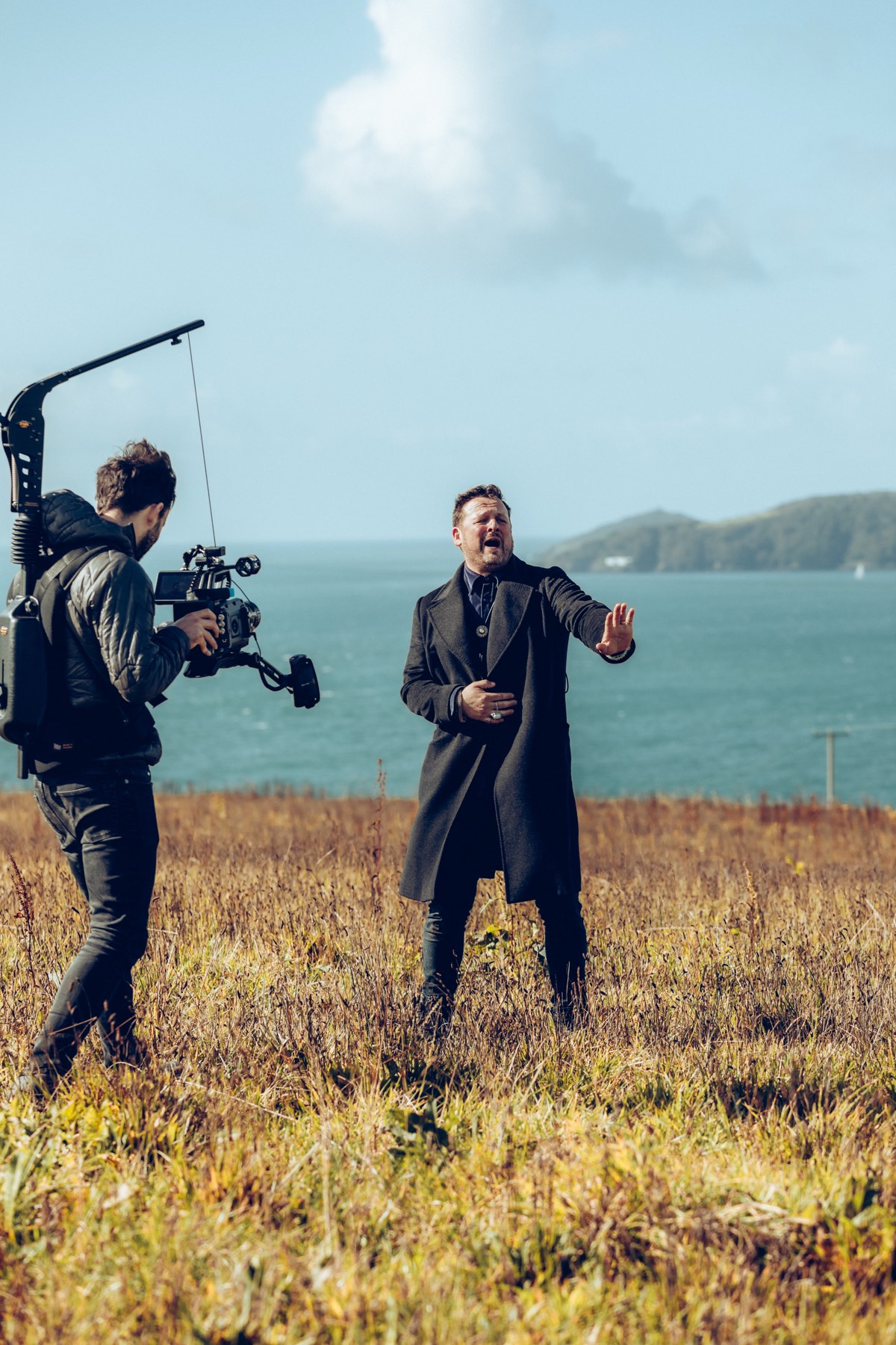 Moss Davis filming with gimbal on clifftop overlooking the sea