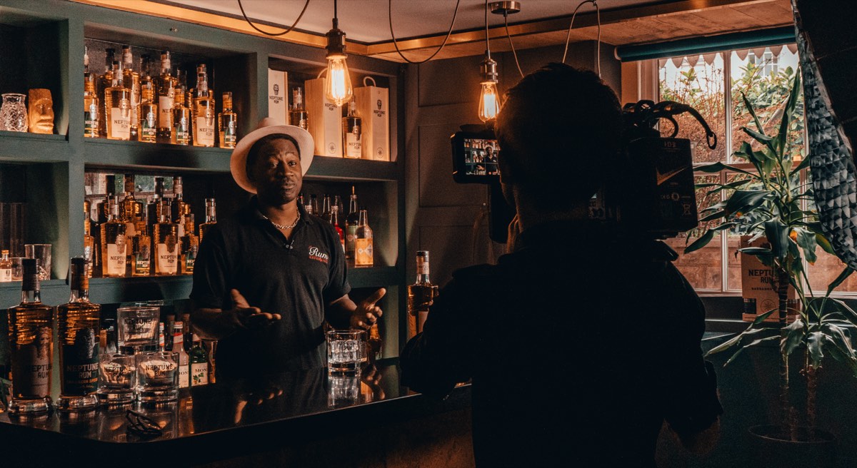 Behind the scenes filming Neptune Rum brand video in atmospheric bar