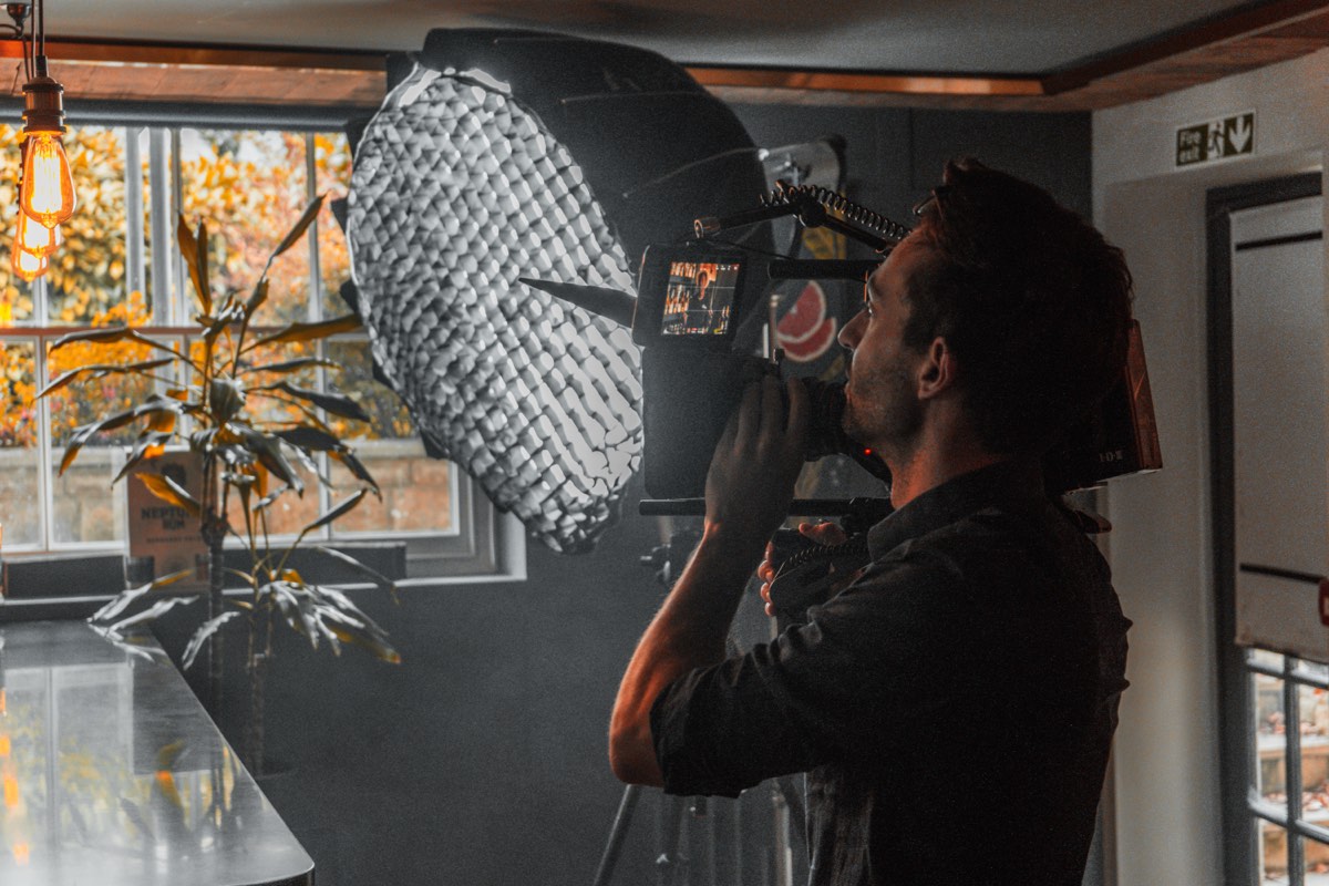 Moss Davis adjusting softbox lighting on a commercial shoot