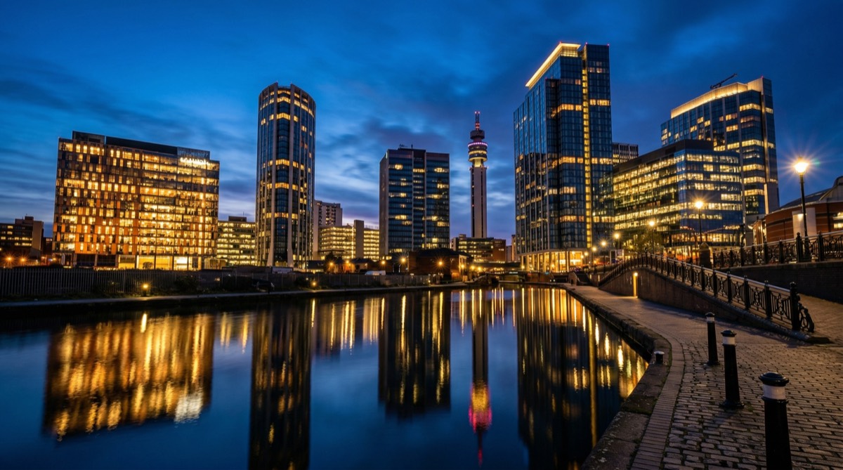 Birmingham city skyline at blue hour with glass skyscrapers reflecting city lights