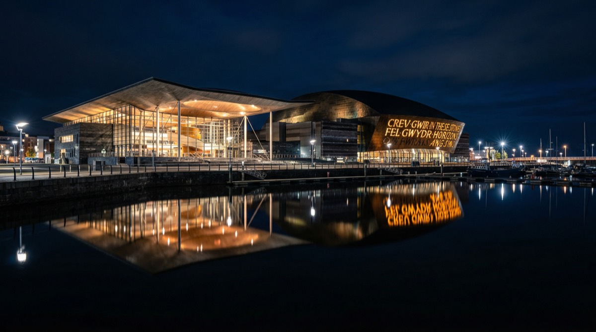 Cardiff Bay at night with Senedd and Wales Millennium Centre reflected in dark water